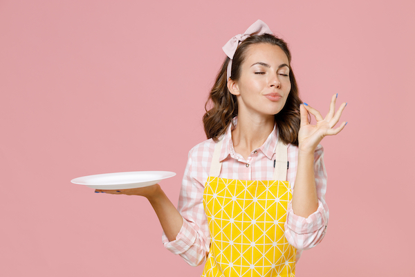 Cute,Young,Woman,Housewife,In,Yellow,Apron,Hold,Empty,Plate