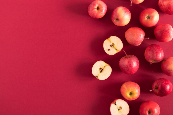 Red,Apples,On,A,Red,Background.,Flat,Lay,,Top,View,