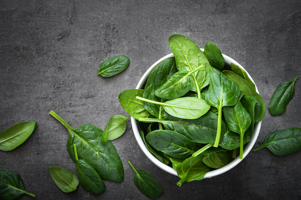 Baby,Spinach,Leaves,In,A,Bowl,On,A,Dark,Background.