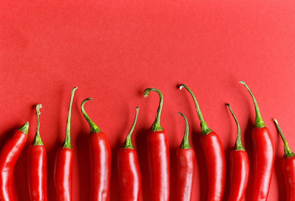 Chili,Pepper,On,Red,Background,,Top,View