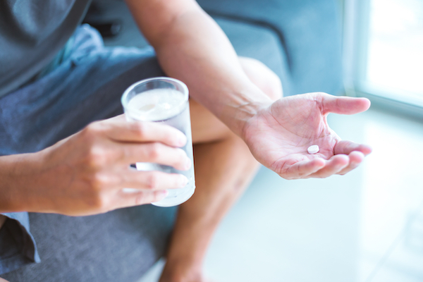 Close,Up,Photo,Of,One,Round,White,Pill,In,Hand.