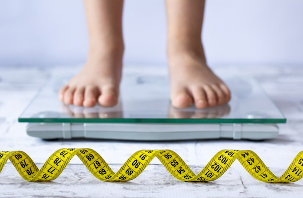 Weight,Control,Concept,With,Centimeter,In,Focus,And,Blurred,Kid’s