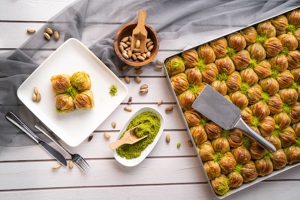 Turkish,Desert,Baklava,With,Peanut,,Pistachio,,Hand,On,Fork,And