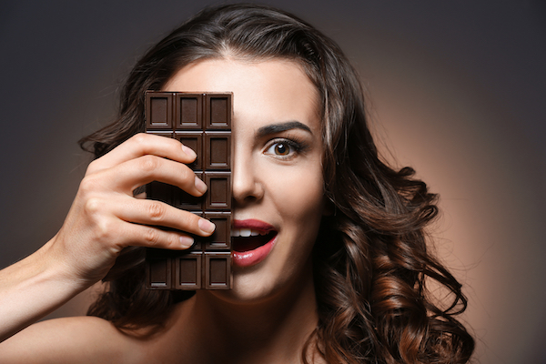 Beautiful,Girl,With,Chocolate,On,Dark,Background