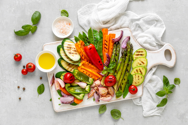 Grilled,Vegetables,Served,On,A,Wooden,Board,With,Olive,Oil