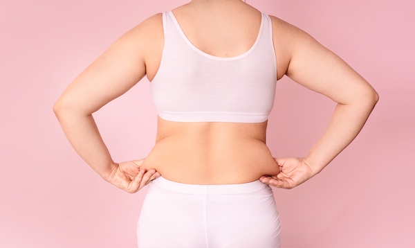 A,Young,Woman,Pinches,Fat,On,The,Side,Of,Her