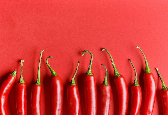 Chili,Pepper,On,Red,Background,,Top,View