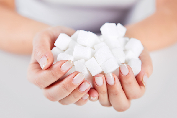 Woman,Holds,In,Hands,Of,A,Handful,Of,Sugar,Cubes
