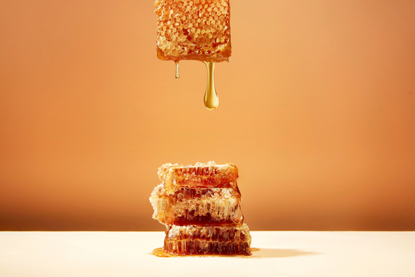 Honeycomb,And,Honey,On,Yellow,Background