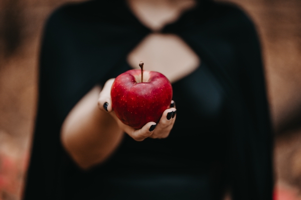 woman-as-witch-offers-red-apple-as-symbol-of-tempt-2022-11-15-02-37-49-utc