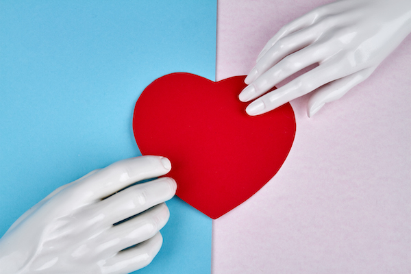 Mannequin hands and red heart.