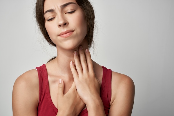 woman in red t-shirt injured finger health problems