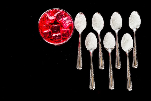 Concept of red fizzy drinks with unhealthy sugar content