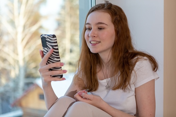 a-young-teenage-girl-is-sitting-on-the-windowsill-2024-11-28-11-11-41-utc