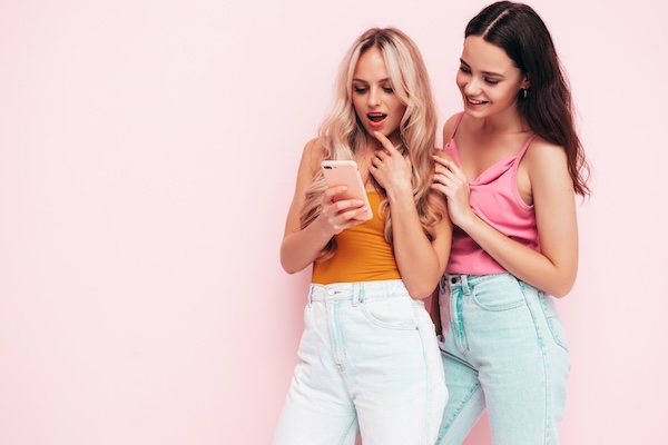 Two young beautiful women posing in studio
