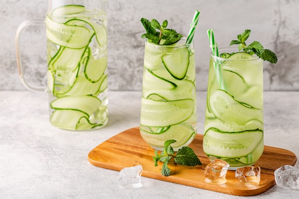 Fresh infused cucumber water on a light background